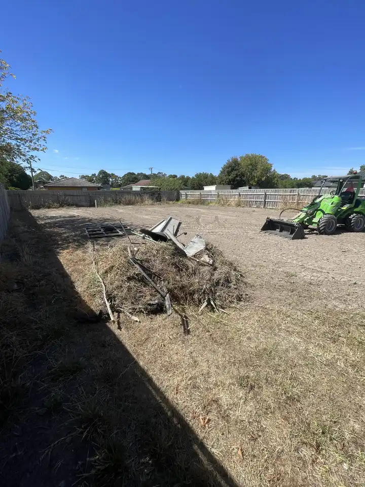 Avant loader performing site clearing and debris removal on a vacant block