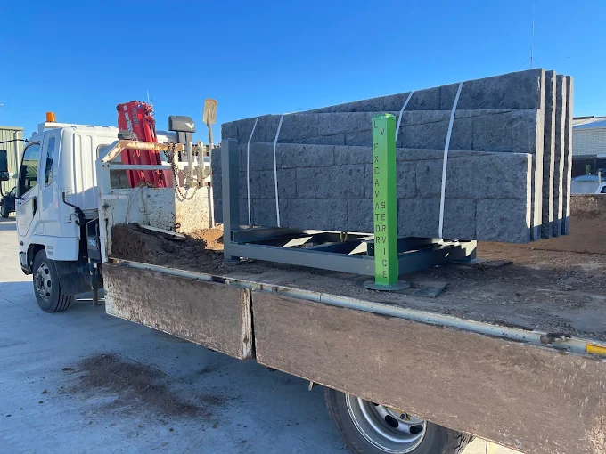 Latrobe Valley Excavator Service tip truck delivering concrete sleepers for a retaining wall