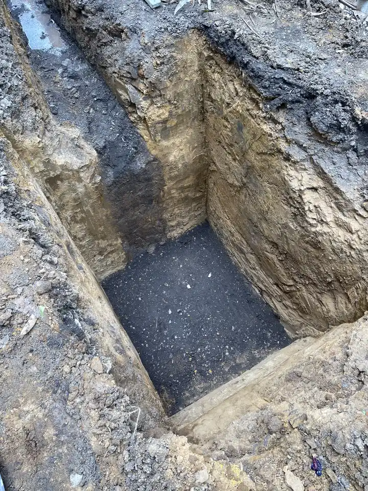 Deep square excavation hole dug for an underground water tank installation