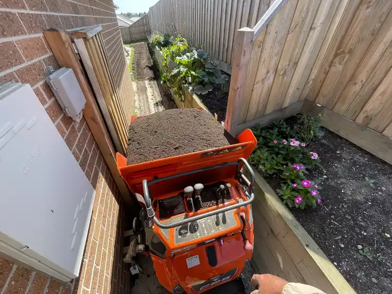 Cormidi mini dumper transporting soil through tight residential side access