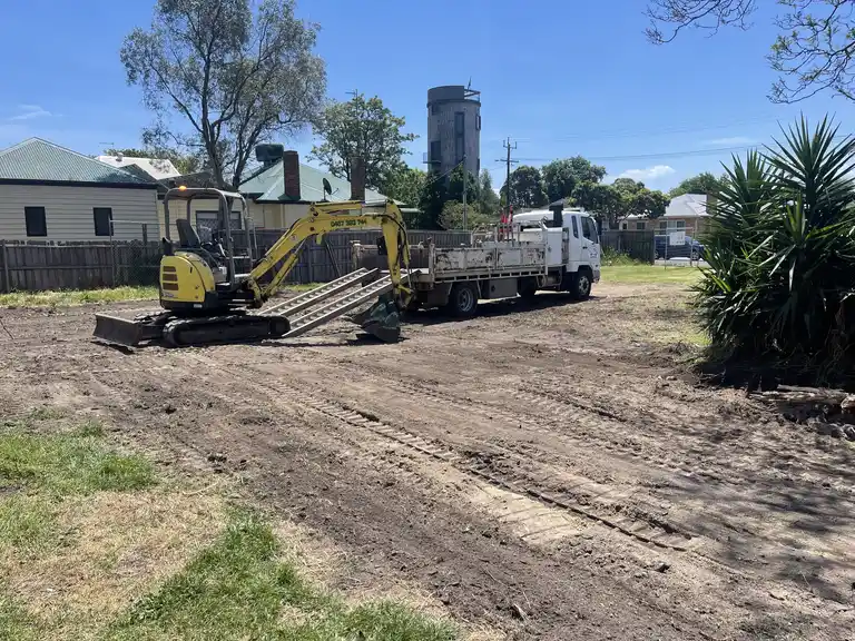 Mini excavator and 8-tonne tip truck on site for residential earthworks